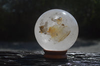 Polished Clear Quartz Ball With Limonite Veils x 1 From Madagascar