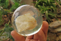 Polished Golden Rutile Quartz in PVC Resin Paperweight Spheres - sold per item - From Brazil