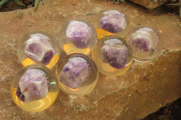 Polished Chevron Amethyst cobbed pieces in PVC Resin Paperweight Spheres - sold per item - From Zambia