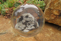 Polished Snowflake Obsidian pieces in PVC Resin Paperweight Spheres - sold per item - From Mexico