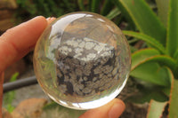 Polished Snowflake Obsidian pieces in PVC Resin Paperweight Spheres - sold per item - From Mexico