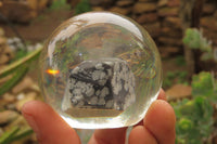 Polished Snowflake Obsidian pieces in PVC Resin Paperweight Spheres - sold per item - From Mexico