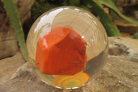 Polished Red Jasper cobbed piece in PVC Resin Paperweight Sphere - sold per item - From South Africa