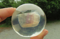 Polished Watermelon Fluorite cobbed piece in PVC Resin Paperweight Sphere - sold per item - From Namibia