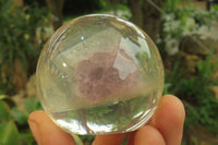 Polished Watermelon Fluorite cobbed piece in PVC Resin Paperweight Sphere - sold per item - From Namibia