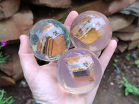 Polished Tigers Eye cobbed piece in PVC Resin Sphere - sold per item - From Northern Cape, South Africa