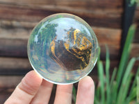 Polished Tigers Eye cobbed piece in PVC Resin Sphere - sold per item - From Northern Cape, South Africa