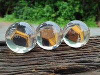 Polished Tigers Eye cobbed piece in PVC Resin Sphere - sold per item - From Northern Cape, South Africa