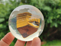 Polished Tigers Eye cobbed piece in PVC Resin Sphere - sold per item - From Northern Cape, South Africa