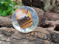 Polished Tigers Eye cobbed piece in PVC Resin Sphere - sold per item - From Northern Cape, South Africa