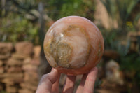 Polished Orange Twist Calcite Sphere x 1 From Maevantanana, Madagascar