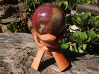 Polished Petrified Red Podocarpus Wood Sphere With Rosewood Stand x 1 From Madagascar - Toprock Gemstones and Minerals 