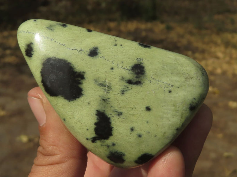 Green stone with sales black spots